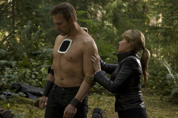 Keller (Jewel Staite) patches up her captor, Kiryk (Mike Dopud).
