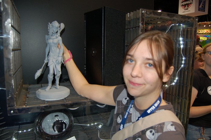 Sculptor Irene Matar poses with one of her Stargate Worlds Jaffa maquettes.
