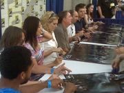 The cast and producers sign autographs. Image from StargateCommand